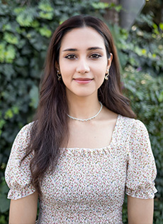 Portrait image of Advanced Counseling Trainee, Madiha Khan, standing in outdoor setting.