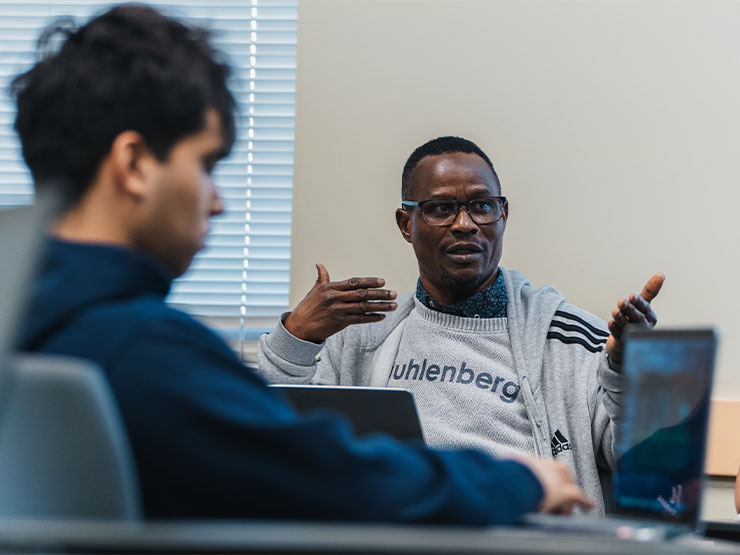 A college student speaks up in a classroom.