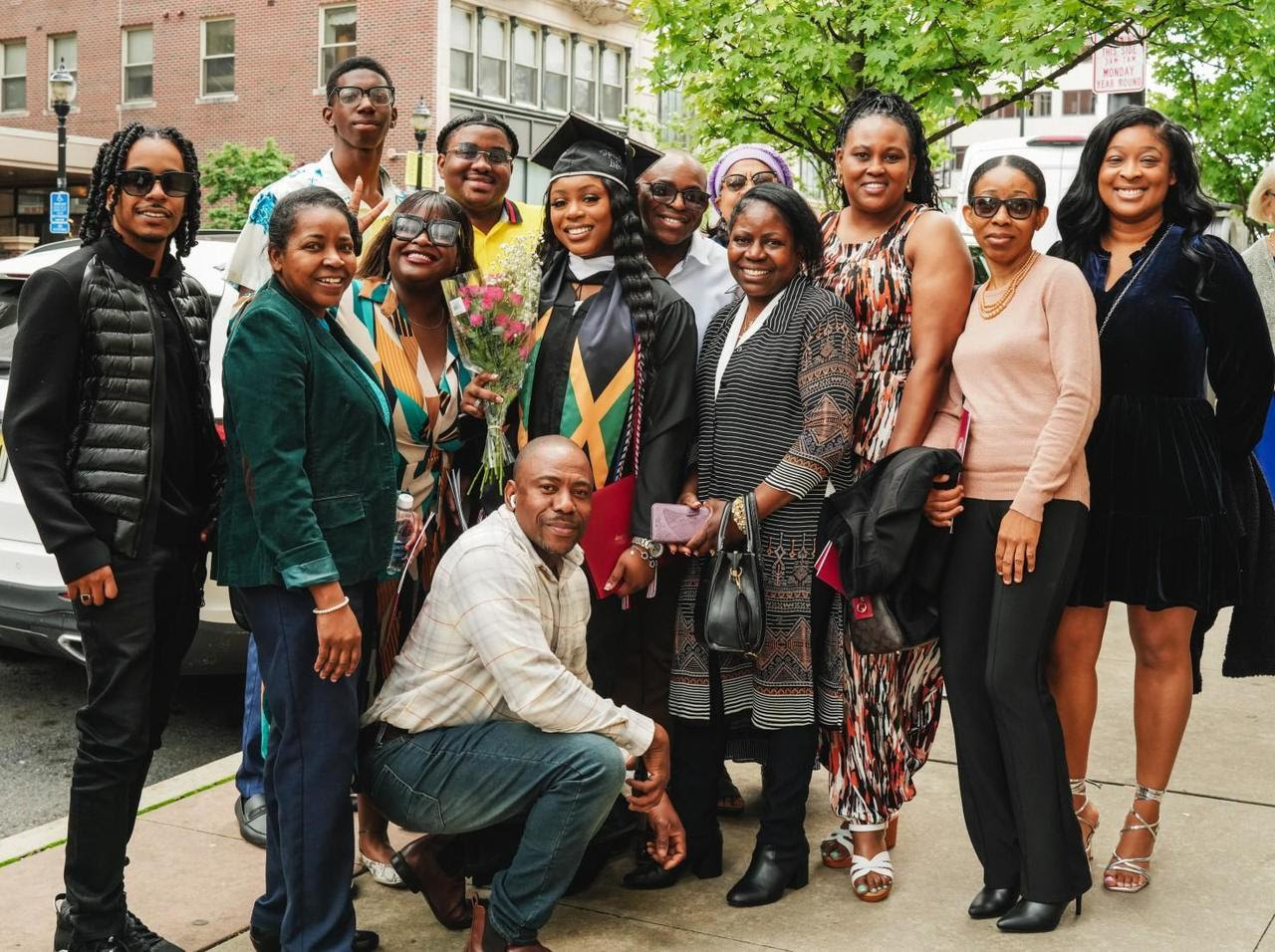 a graduate posing with family