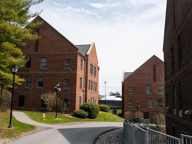 Brick college housing buildings on a sunny spring day.