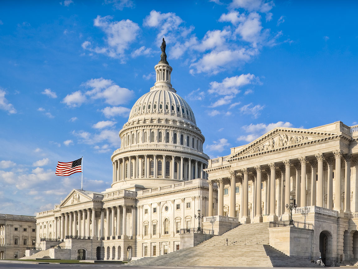 The U.S. Capitol building on a sunny day with blue skies